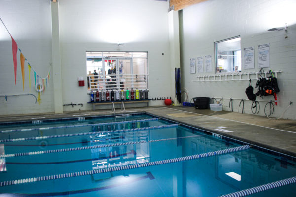 The training pool with tanks lined up on a bench and ranks for trying equipment.