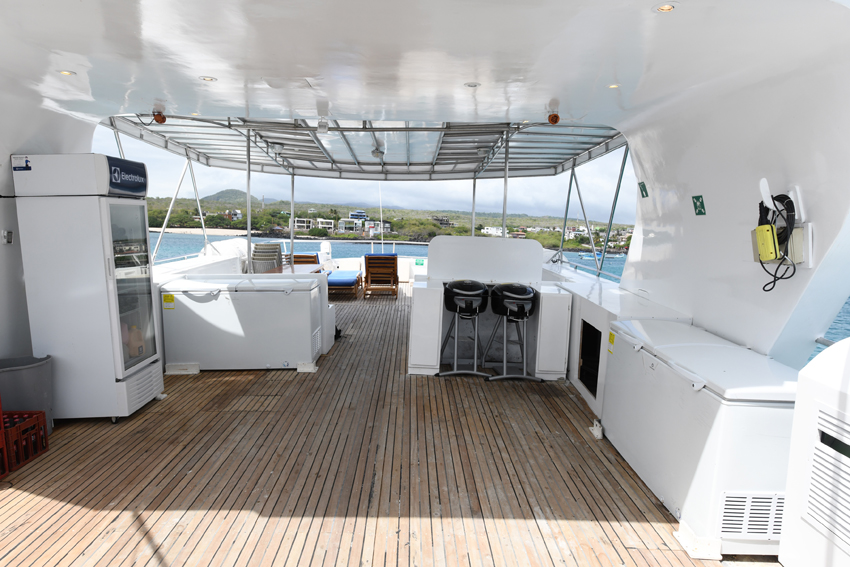 The back of the Humboldt Explorer sundeck is covered with a wood style floor and several surfaces for drinks and stuff. 